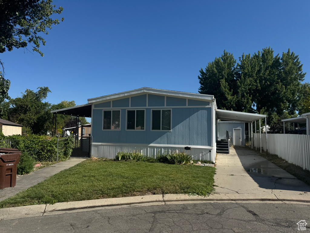 Manufactured / mobile home with a carport and driveway