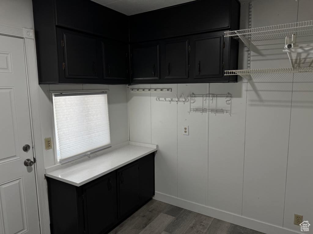 Laundry area with wood finished floors
