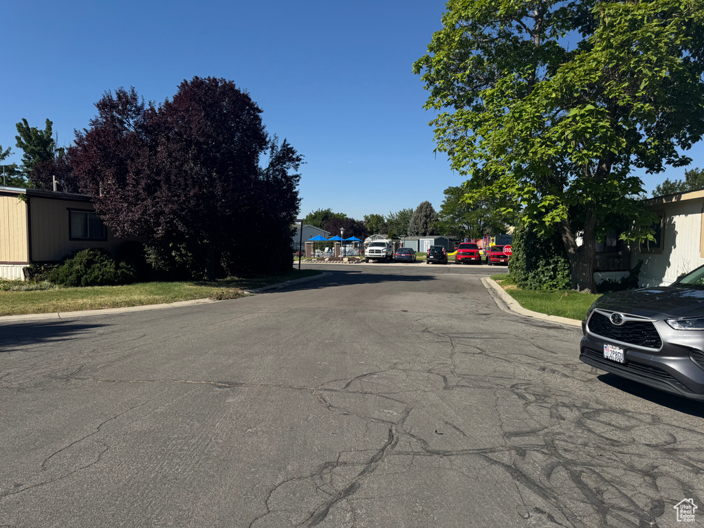View of asphalt street featuring curbs