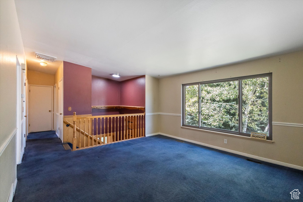 Unfurnished room featuring carpet flooring and baseboards