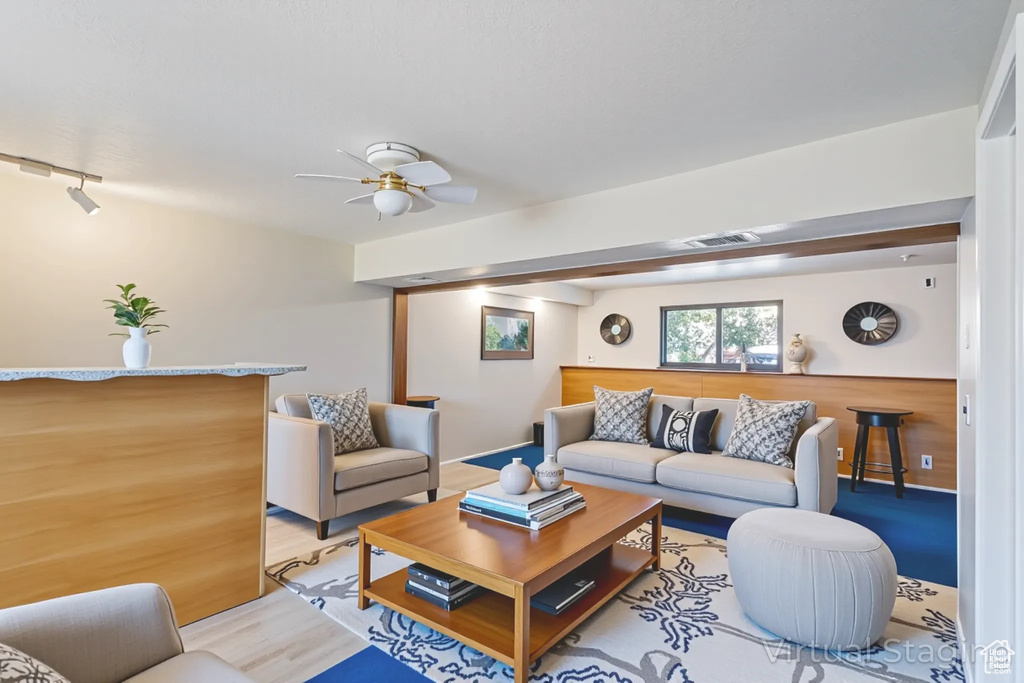 Living area with light wood-style flooring and ceiling fan