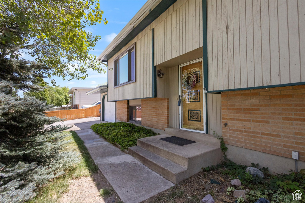 Doorway to property featuring brick siding