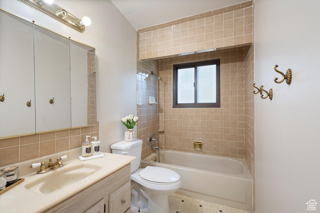 Full bath featuring vanity, shower / bath combination, and decorative backsplash