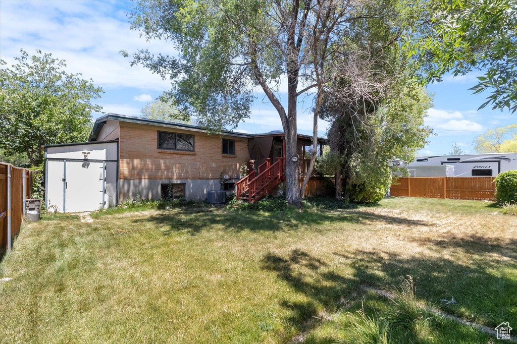 View of yard featuring stairway and a storage unit