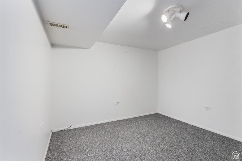 Carpeted spare room with baseboards