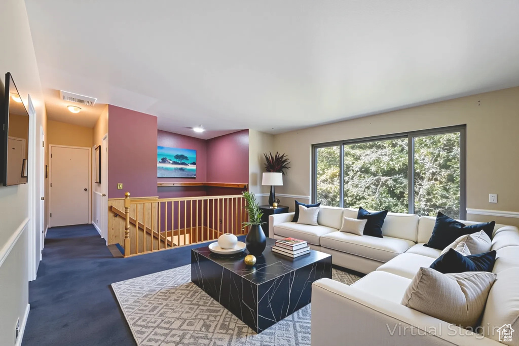 Carpeted living area with baseboards