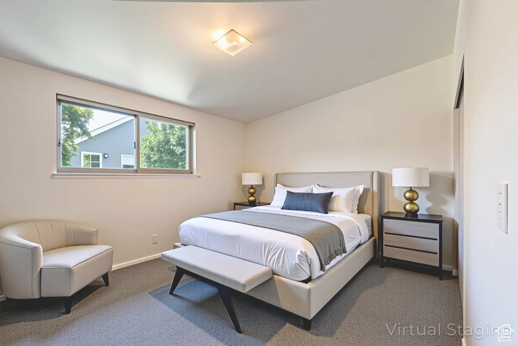Carpeted bedroom featuring baseboards