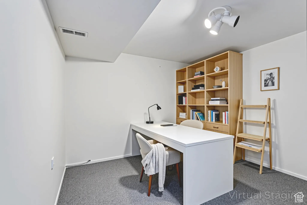 Home office featuring dark carpet