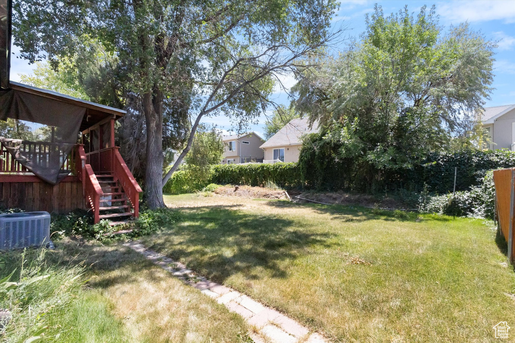View of yard with stairs and a wooden deck