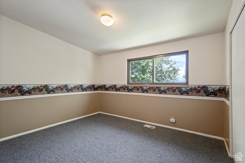 Unfurnished room featuring baseboards and carpet floors