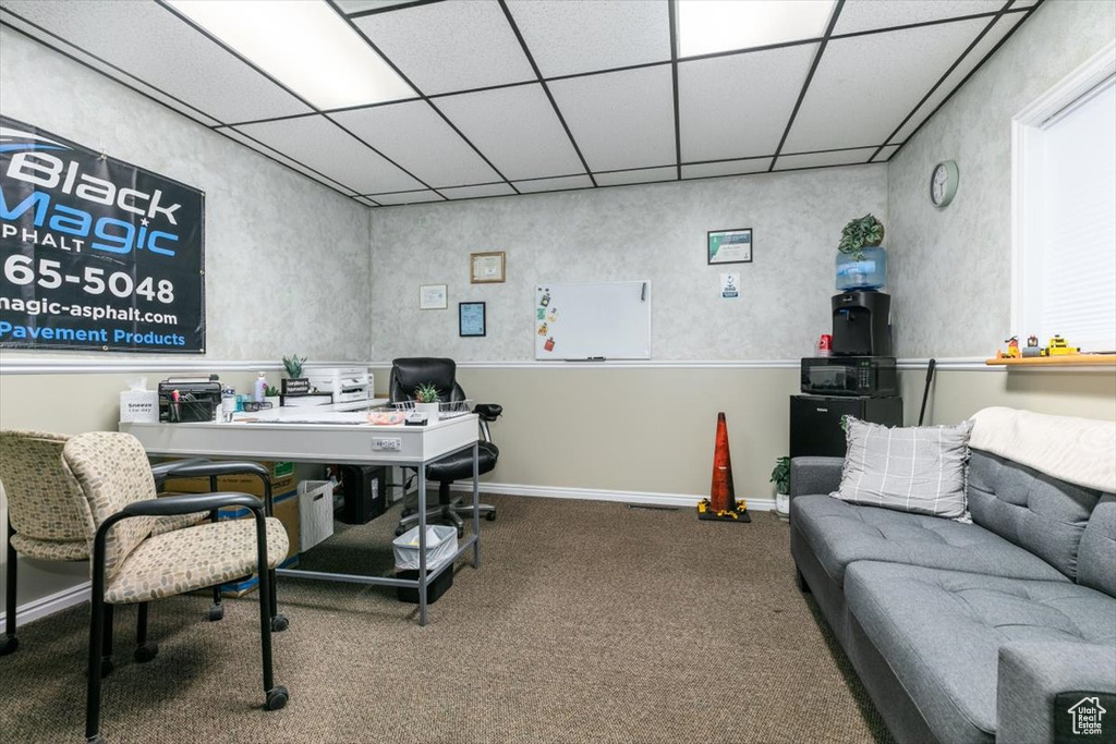 Carpeted office featuring a paneled ceiling