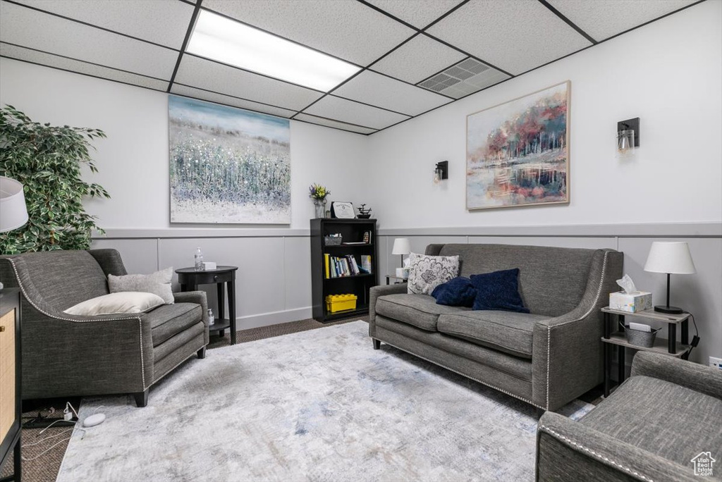 Living room with carpet floors and a drop ceiling