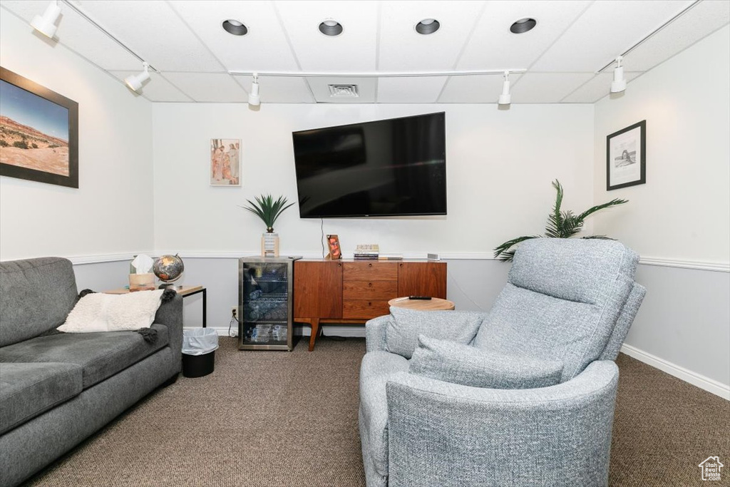 Living area with track lighting, carpet flooring, and wine cooler