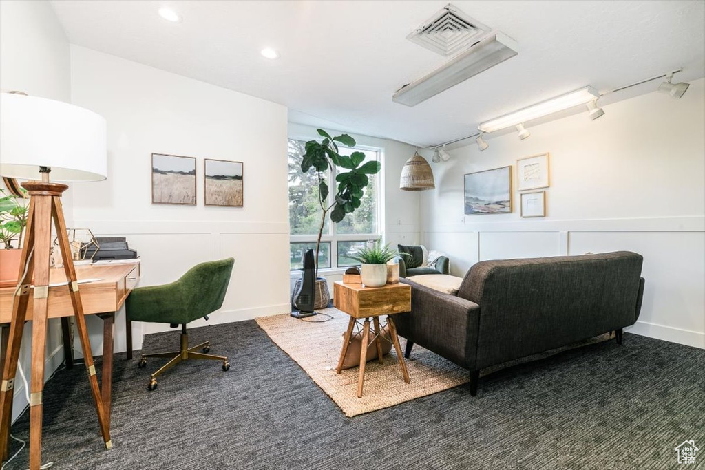 Carpeted office space featuring a decorative wall, a wainscoted wall, rail lighting, and recessed lighting