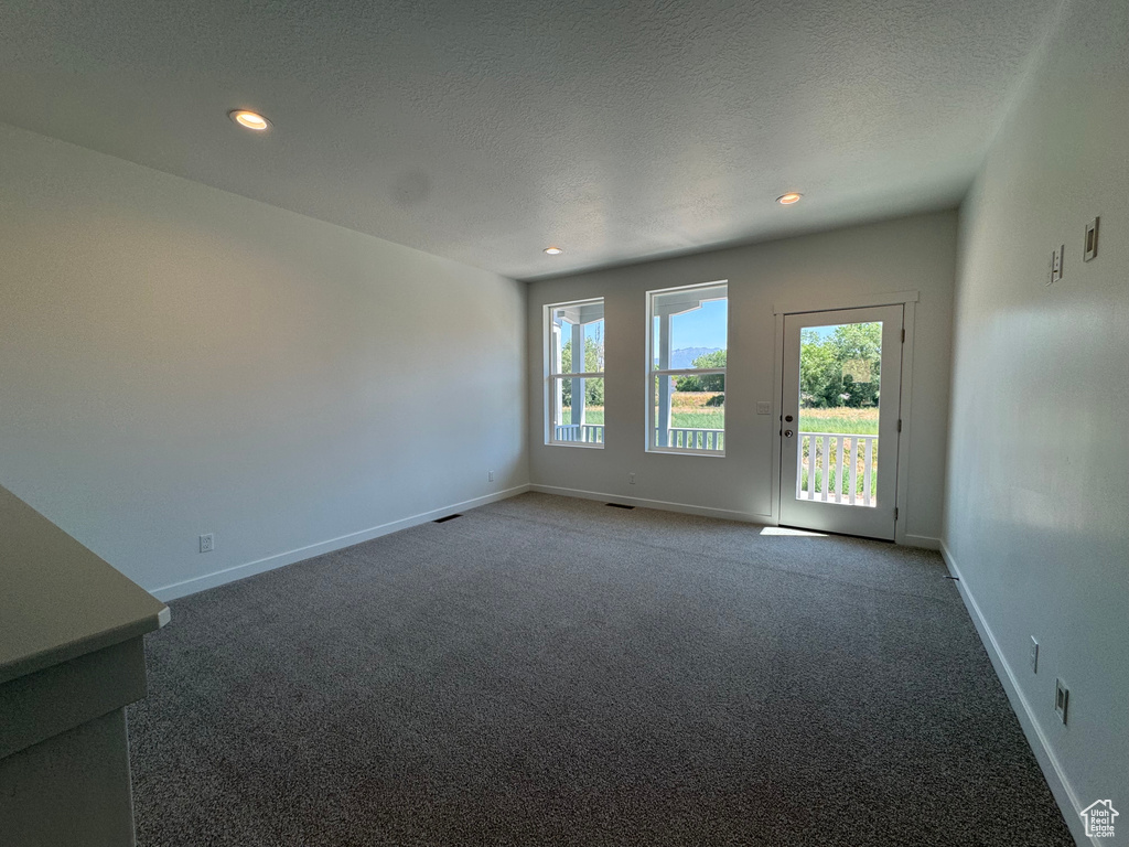 Spare room with carpet flooring, recessed lighting, and a textured ceiling