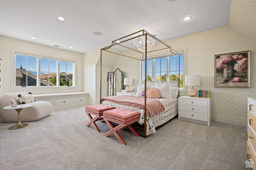 Bedroom with wallpapered walls, carpet flooring, and recessed lighting