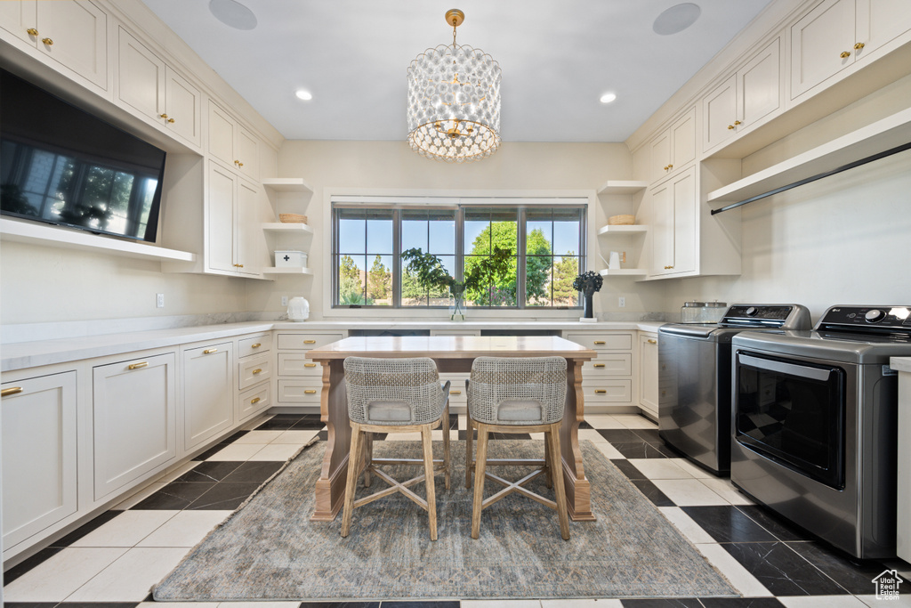Kitchen with open shelves, independent washer and dryer, a chandelier, light countertops, and recessed lighting