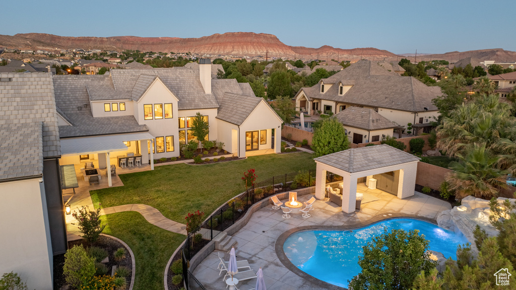 View of swimming pool featuring a patio, a fenced backyard, and a mountain view