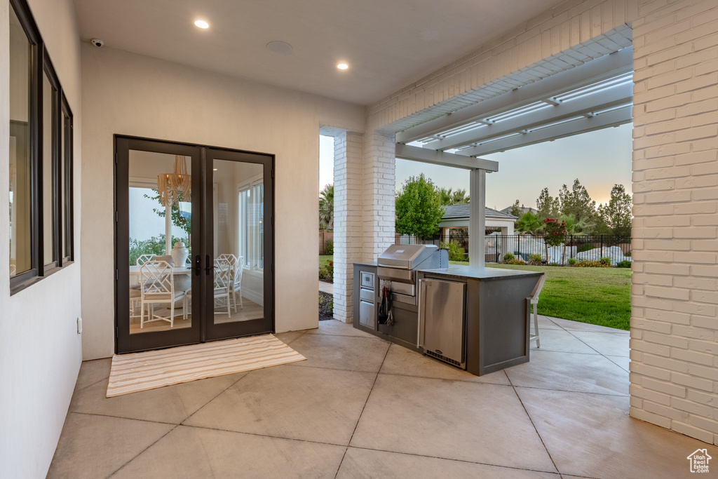 View of patio with exterior kitchen and french doors