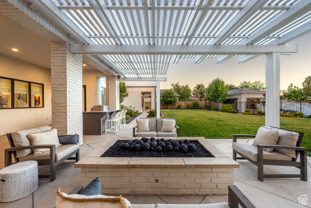 View of patio with an outdoor living space with a fire pit and a pergola