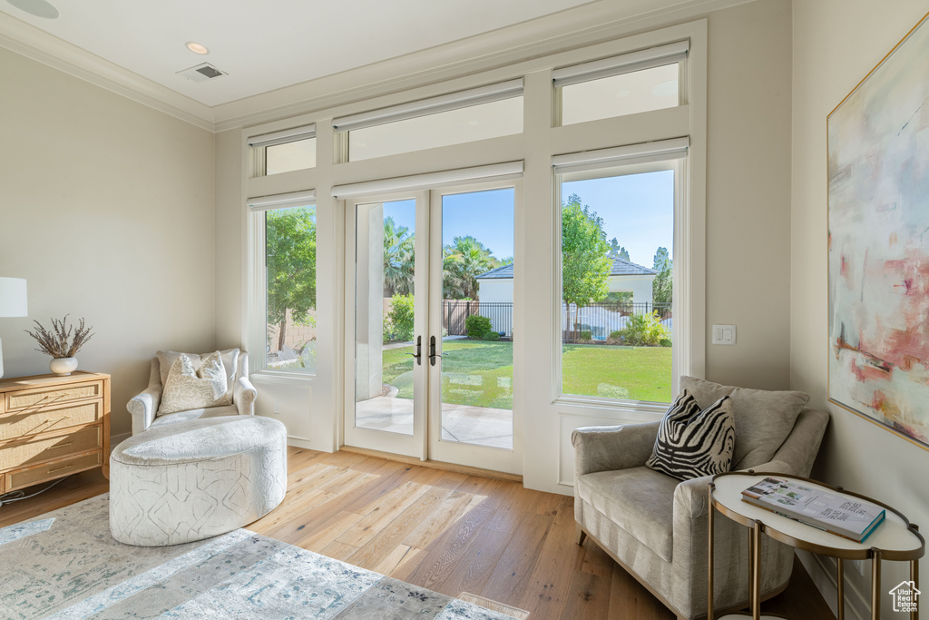 Sitting room featuring ornamental molding, hardwood / wood-style floors, and french doors