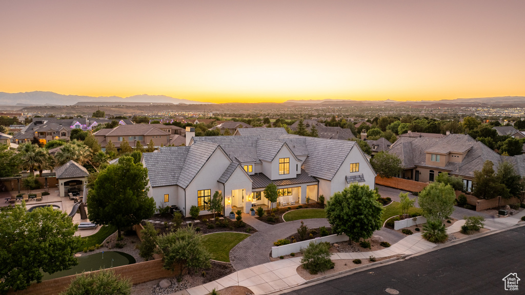 View of front of property with stucco siding, a mountain view, and a residential view