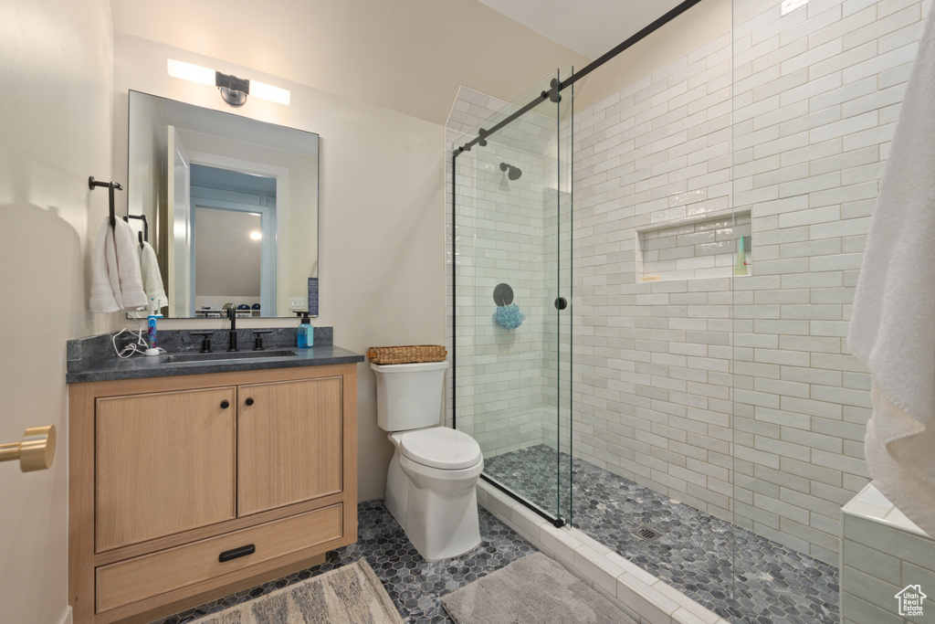 Bathroom featuring a stall shower and vanity