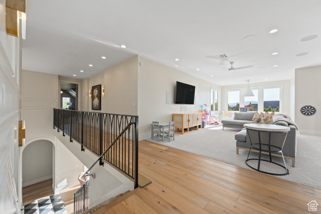 Living area with hardwood / wood-style flooring, recessed lighting, and a ceiling fan