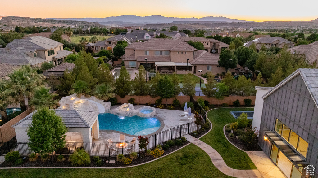 Aerial perspective of suburban area featuring a pool area and a mountain backdrop