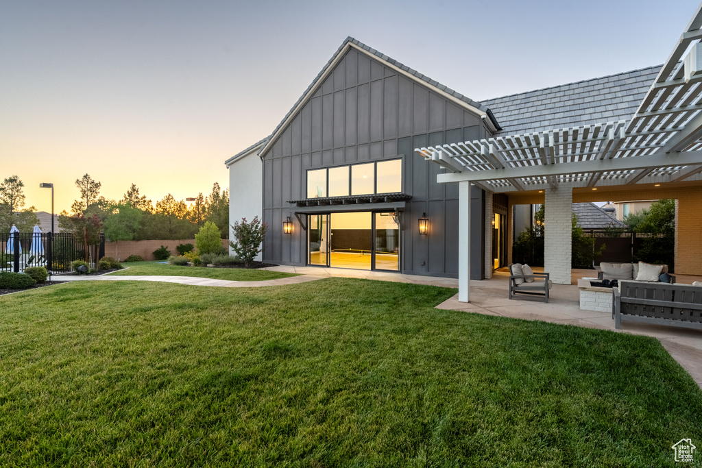 Back of property featuring board and batten siding, an outdoor hangout area, a patio area, and a pergola