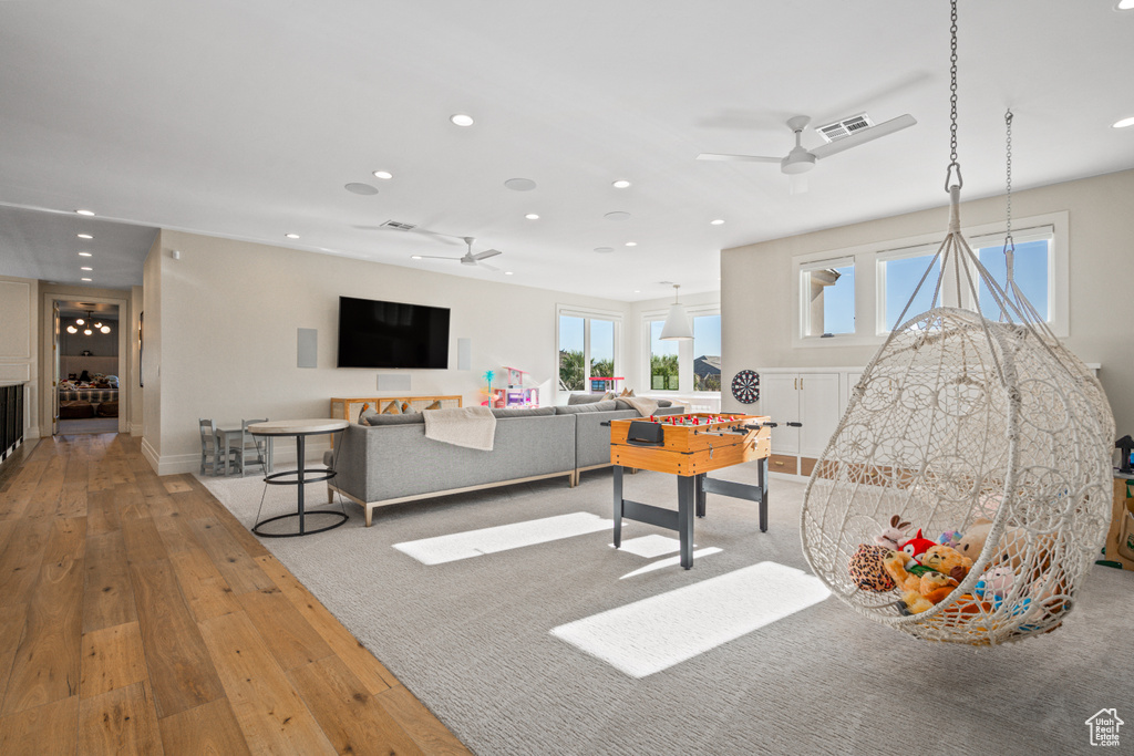 Recreation room featuring ceiling fan, recessed lighting, and wood-type flooring
