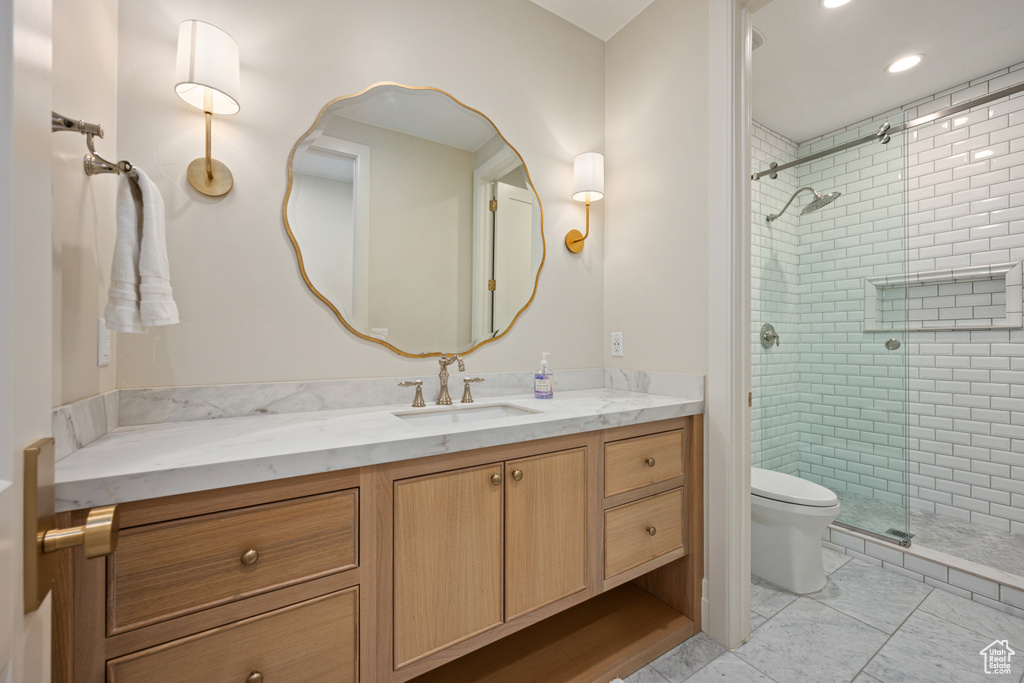 Full bath with vanity, a shower stall, and recessed lighting