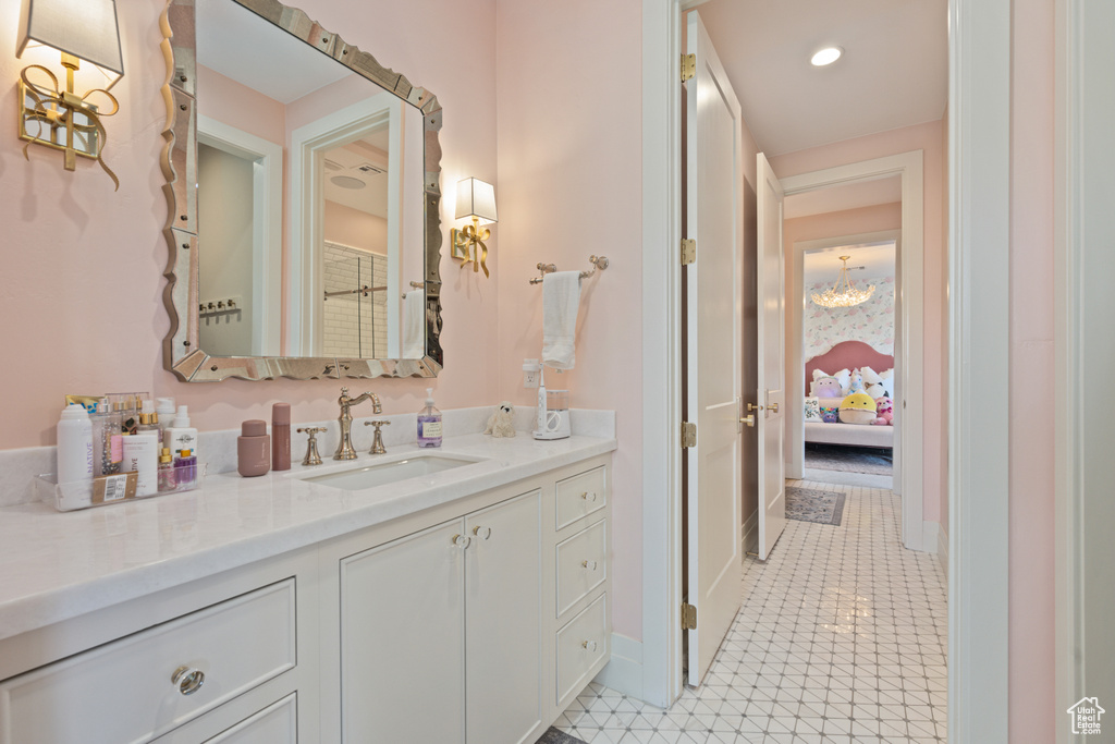 Bathroom featuring vanity, tile patterned flooring, and recessed lighting