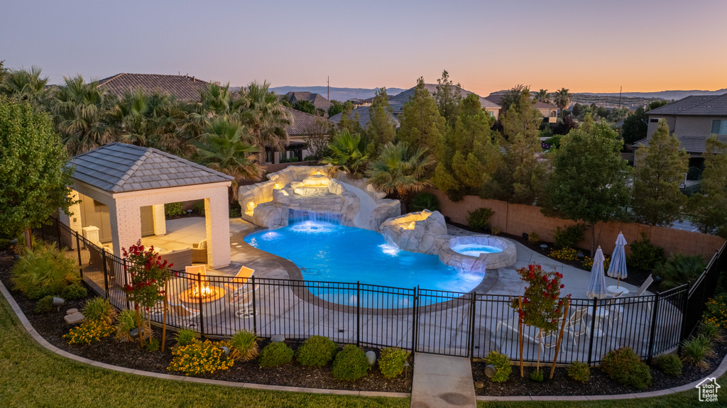 View of swimming pool with a gazebo, a fire pit, a fenced backyard, a patio, and a pool with connected hot tub