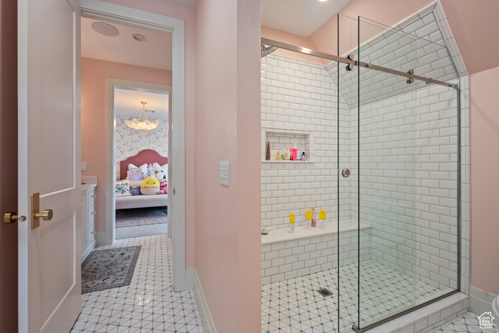 Ensuite bathroom with a stall shower and tile patterned flooring