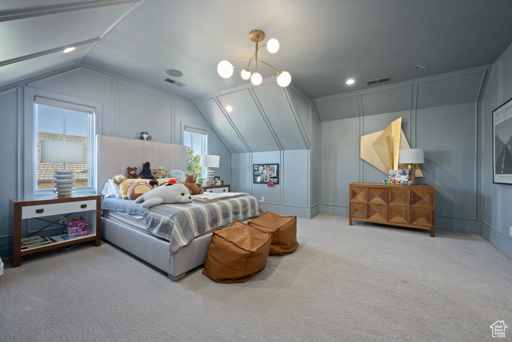 Carpeted bedroom with vaulted ceiling, a decorative wall, a chandelier, and recessed lighting