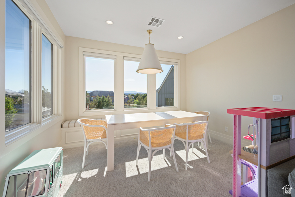 Dining space with healthy amount of natural light, carpet flooring, and recessed lighting