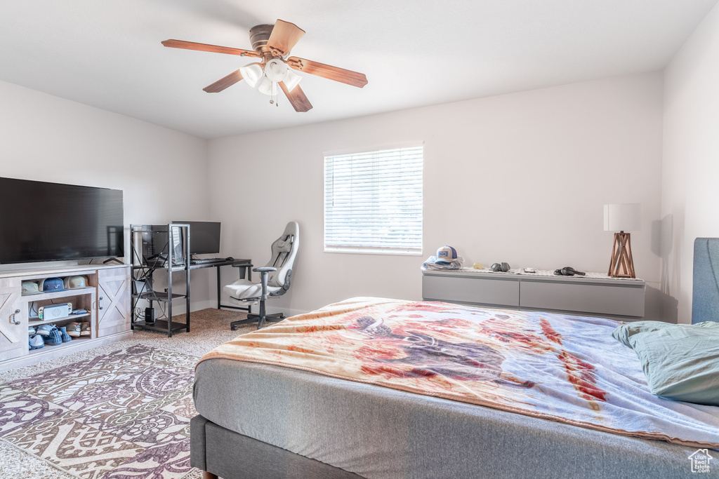 Bedroom featuring a ceiling fan and baseboards