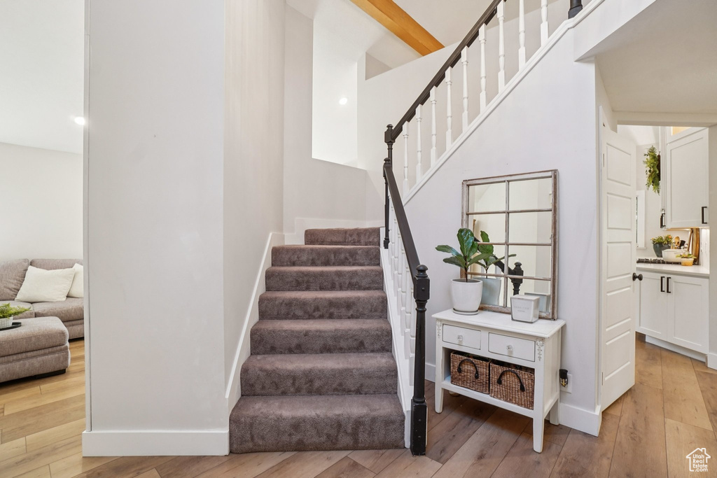 Staircase featuring hardwood / wood-style floors