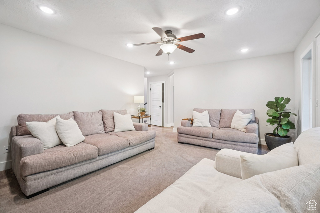 Living room with ceiling fan and recessed lighting