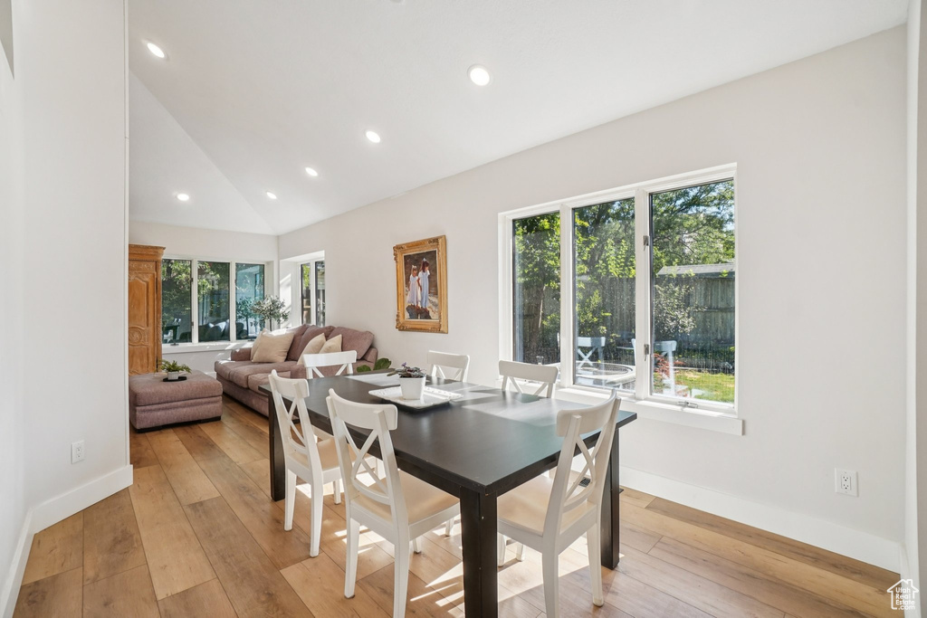 Dining room featuring recessed lighting, light wood finished floors, and vaulted ceiling