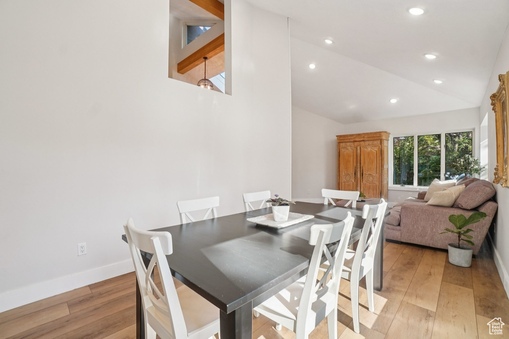 Dining area featuring light wood finished floors, recessed lighting, and high vaulted ceiling
