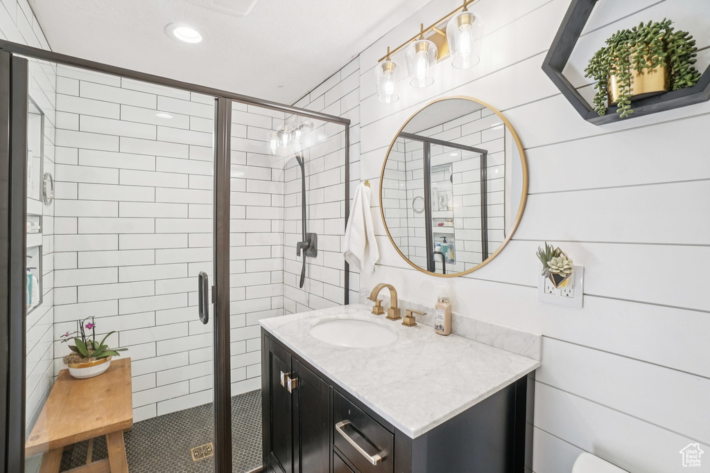 Full bathroom featuring vanity, a shower stall, and recessed lighting