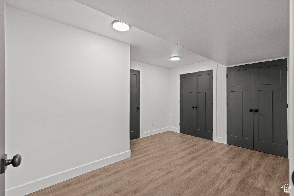 Unfurnished bedroom featuring baseboards and wood finished floors