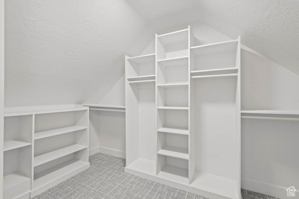 Walk in closet with lofted ceiling