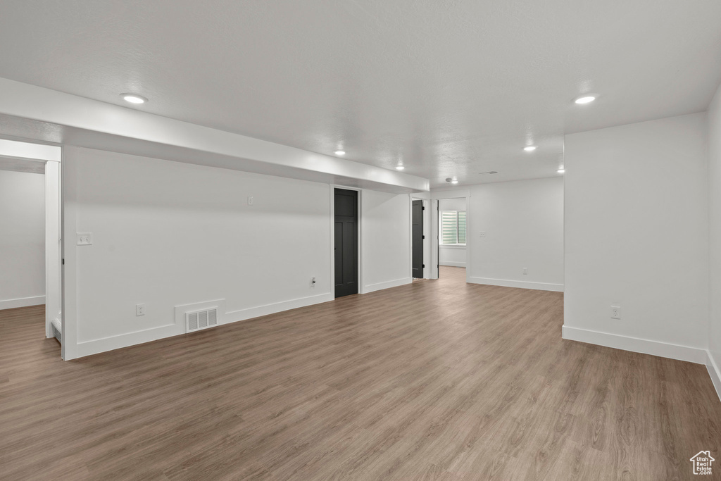 Below grade area featuring recessed lighting and light wood-style flooring