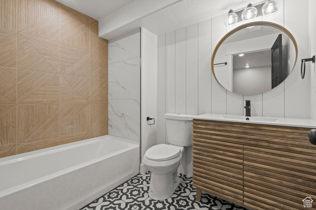 Bathroom featuring vanity, shower / tub combination, and tile patterned floors