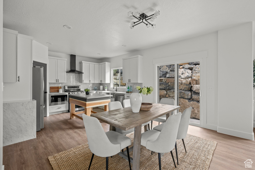 Dining space with light wood-style floors