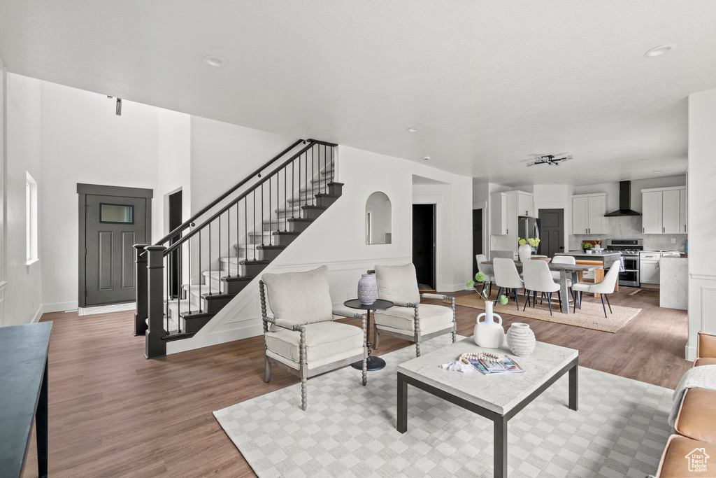 Living area with stairs, light wood finished floors, and recessed lighting