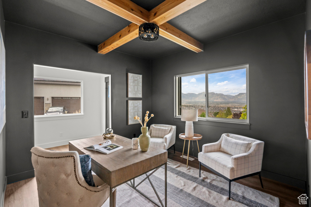 Office area featuring beamed ceiling, wood finished floors, and a mountain view